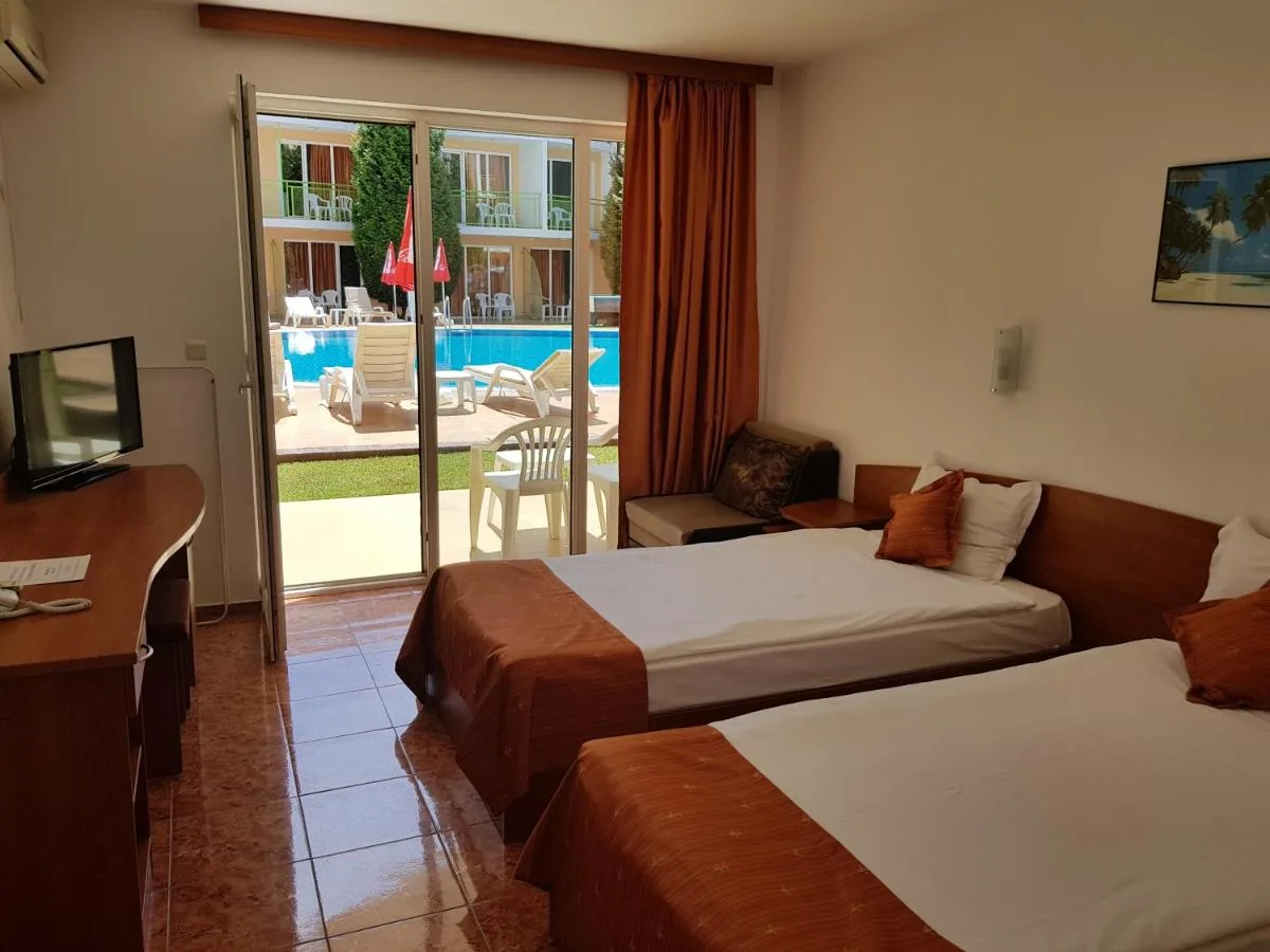 Deluxe Triple Room at the Sun City Hotel with balcony and pool view